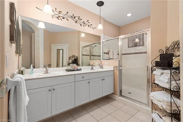 a spacious bathroom with a double vanity sink mirror and