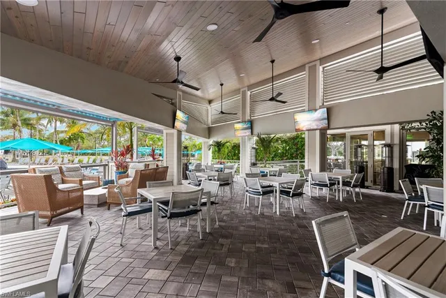 a living room with lots of furniture and a large window