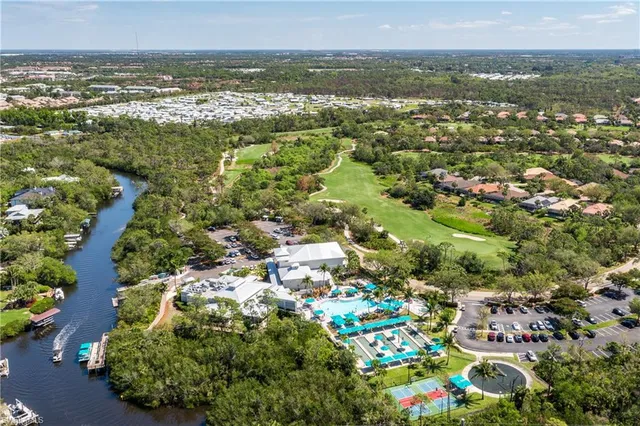 an aerial view of residential houses with outdoor space and trees
