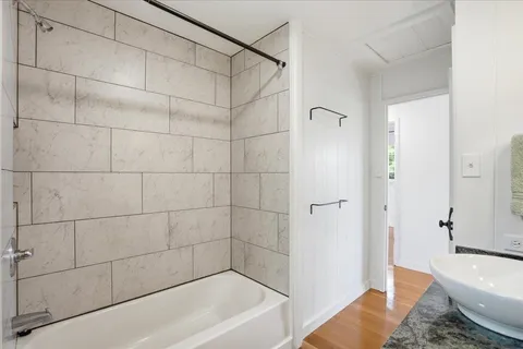 a bathroom with a bathtub and shower