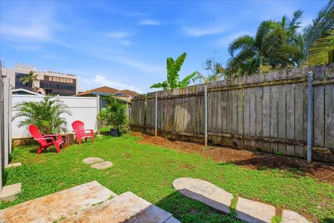a view of a backyard with a garden and entertaining space