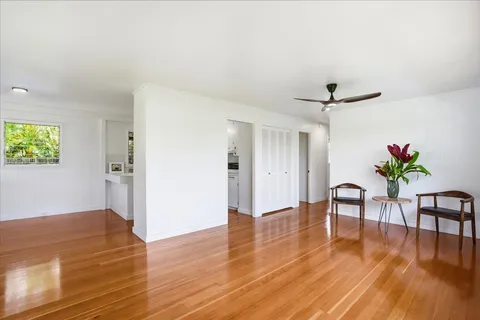 a view of a livingroom with a hardwood floor and a ceiling fan