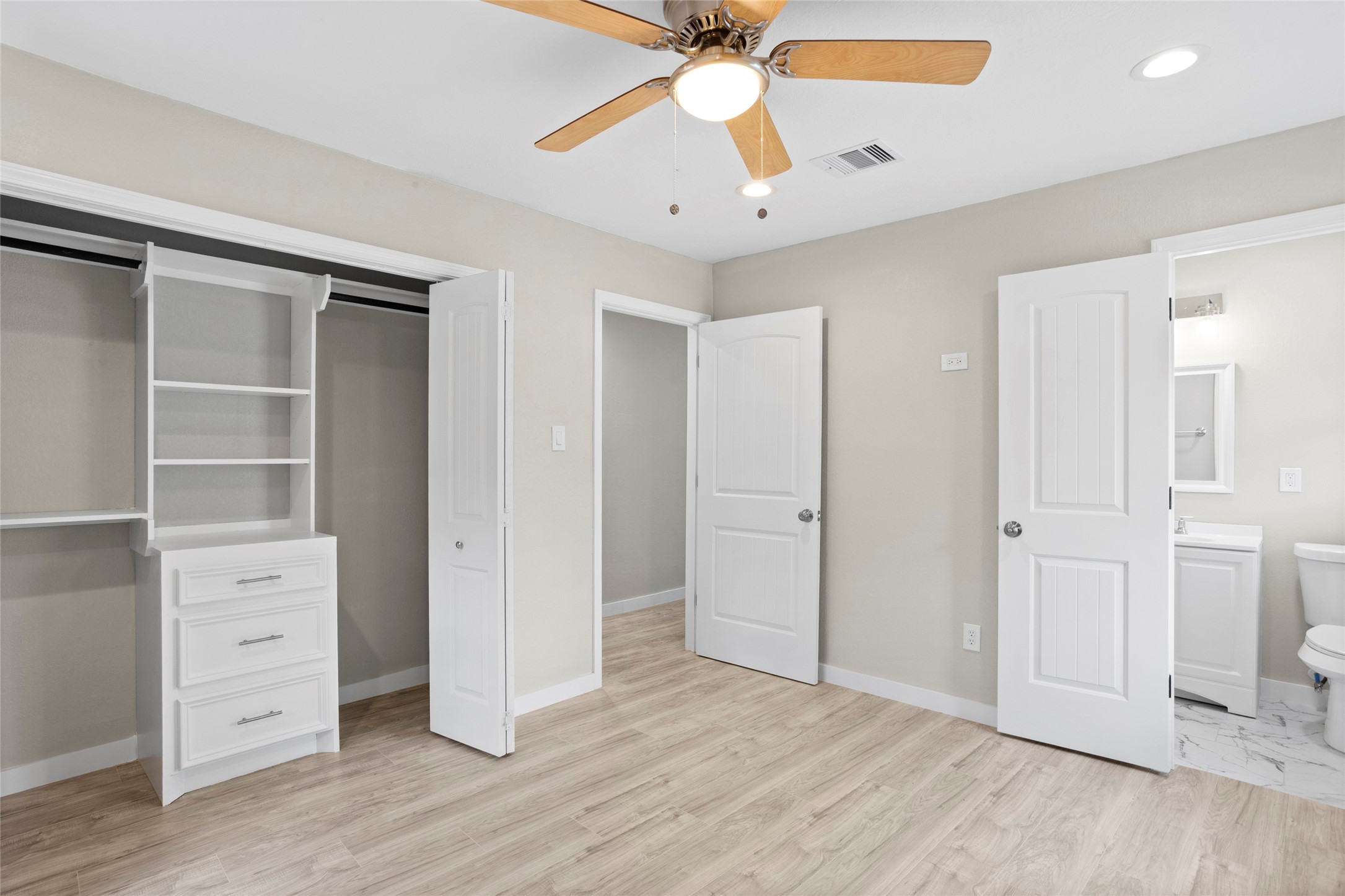 10127 Tolman Street Houston, TX 77034 - Photo 11 of 27 This primary bedroom is a bright, airy space that utilizes a neutral color palette and clean lines to create a modern, restful environment.