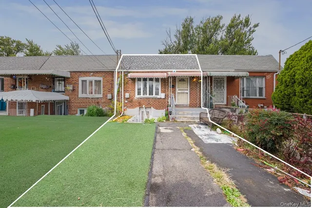 a front view of a house with a yard table and chairs