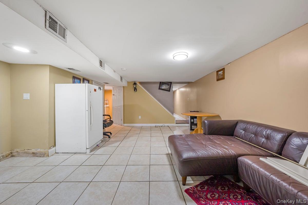 130-24 Springfield Boulevard Queens, NY 11413 - Photo 14 of 20 a living room with furniture and a table