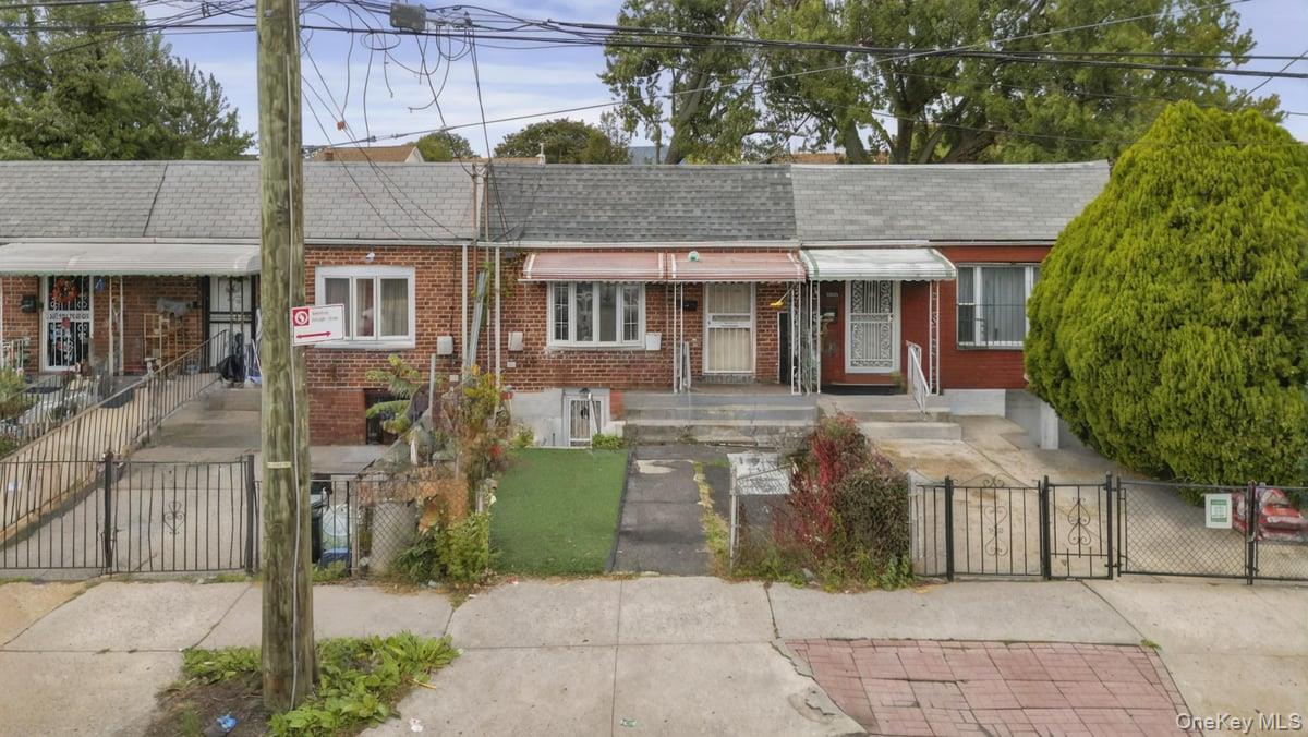 130-24 Springfield Boulevard Queens, NY 11413 - Photo 20 of 20 a front view of a house with a garden