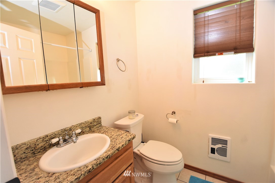 9 Hahn Road Omak, WA 98841 - Photo 23 of 34 a bathroom with a toilet a sink and a mirror