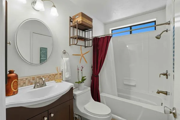 a bathroom with a sink a toilet and a mirror
