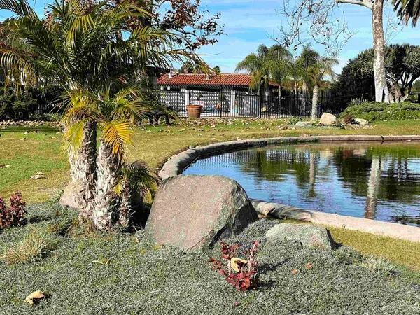 a view of a house with a yard and sitting area
