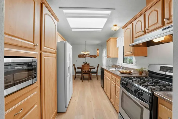 a kitchen with stainless steel appliances granite countertop a stove and a refrigerator
