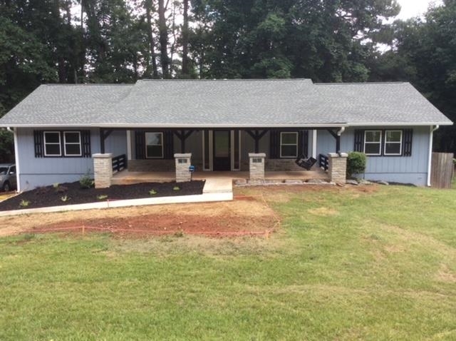 7350 Hobgood Road Fairburn, GA 30213 - Photo 1 of 1 a front view of house with yard and seating area