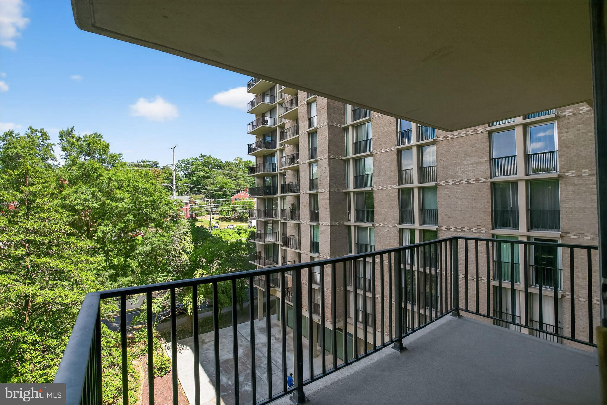 4600 South Four Mile Run Drive, Unit 421 Arlington, VA 22204 - Photo 2 of 17 Urban balcony with lush green views.