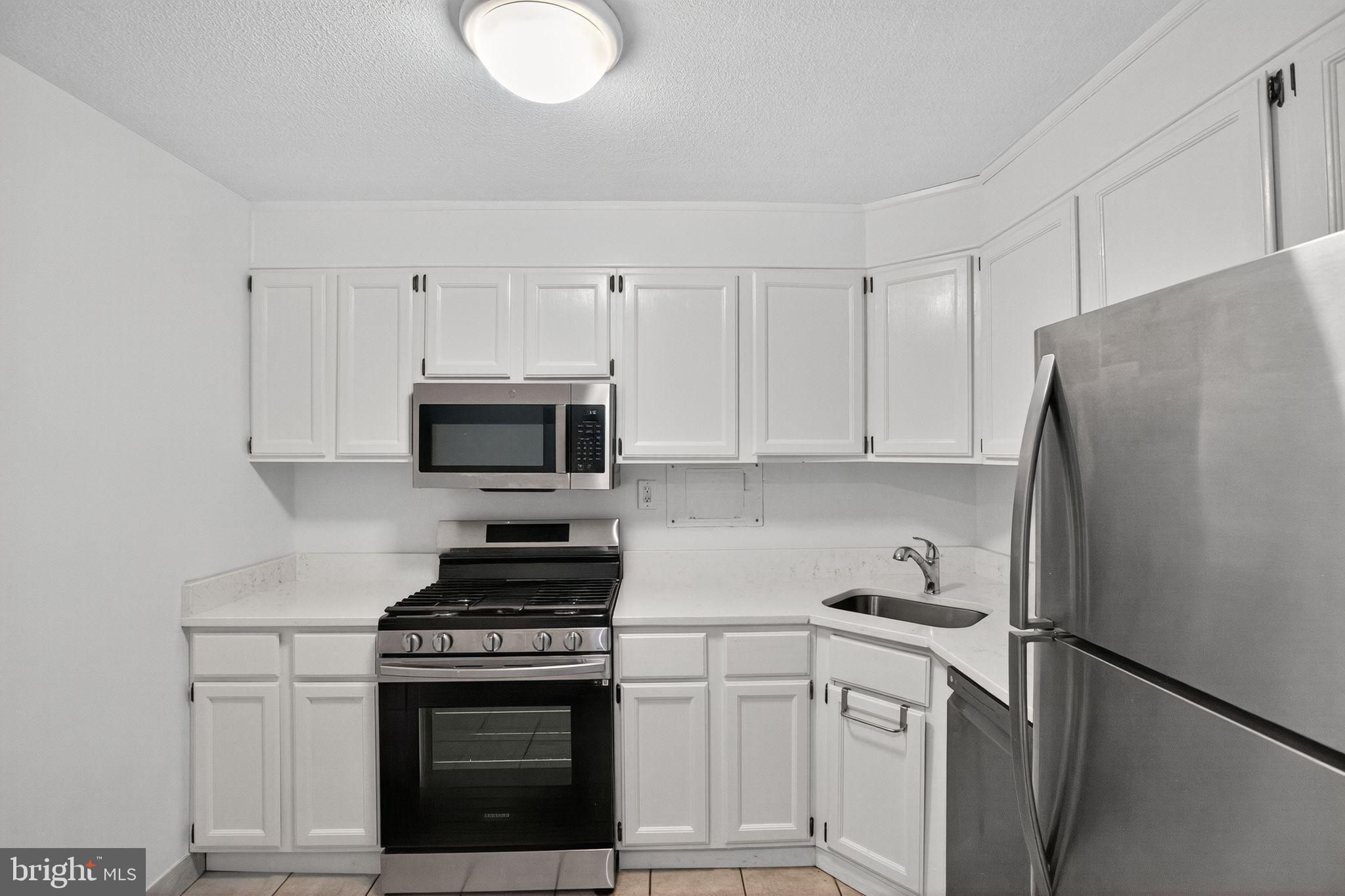 4600 South Four Mile Run Drive, Unit 421 Arlington, VA 22204 - Photo 6 of 17 Modern kitchen with sleek white cabinetry.