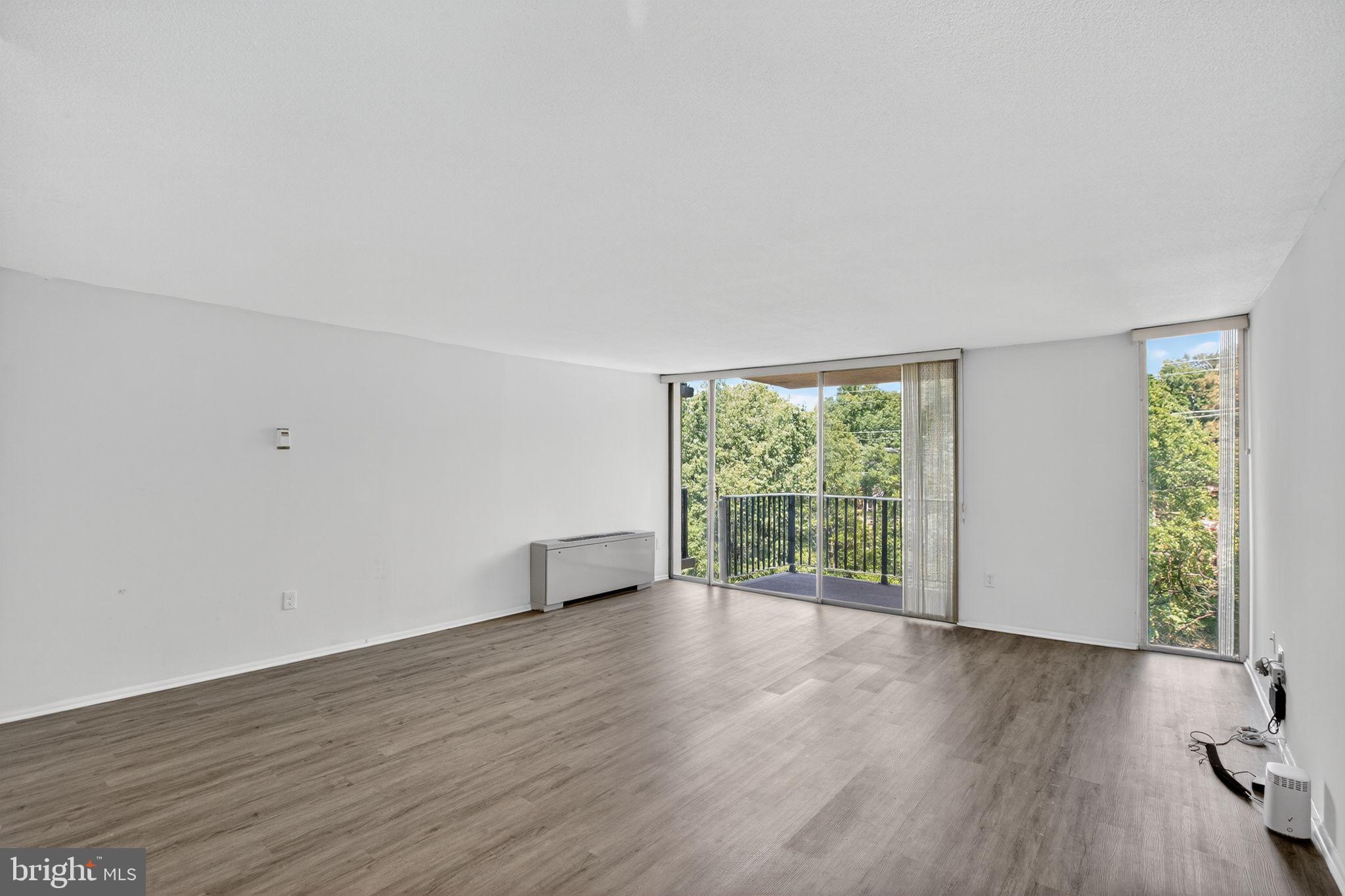 4600 South Four Mile Run Drive, Unit 421 Arlington, VA 22204 - Photo 8 of 17 Spacious room with serene outdoor views.