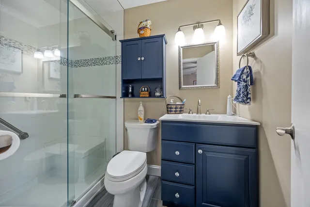 a bathroom with a sink toilet and shower