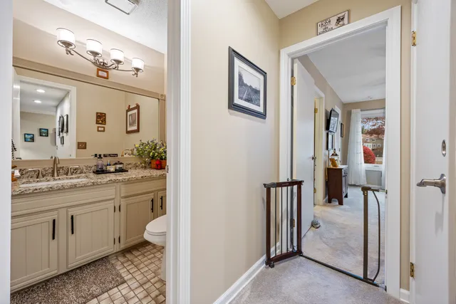 a spacious bathroom with a granite countertop sink a mirror and a shower