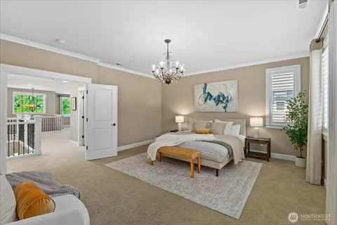 a spacious bedroom with a bed a chandelier and a couch