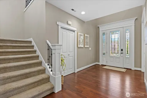 a view of an entryway with wooden floor