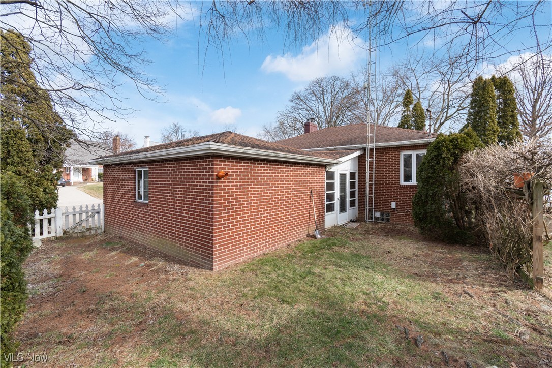 1527 Ridge Road Northwest Canton, OH 44703 - Photo 22 of 27 Rear view of house with a lawn