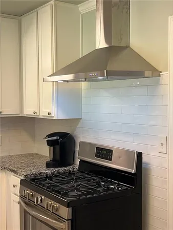a stove top oven sitting inside of a kitchen