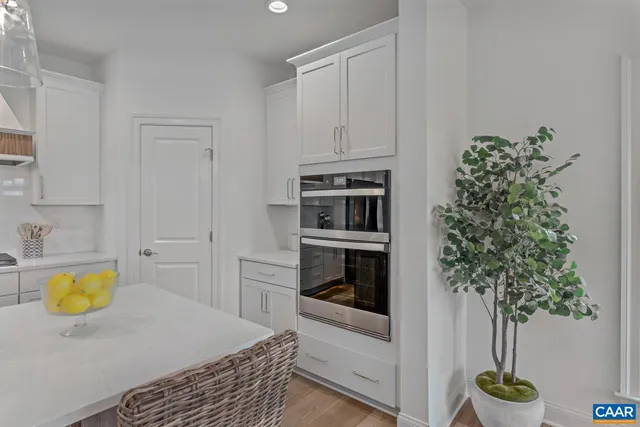 a kitchen with a refrigerator and a stove top oven