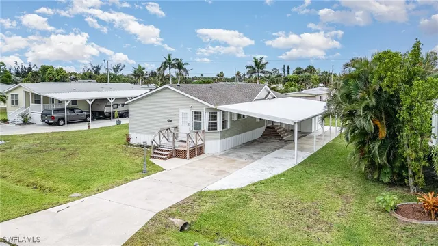 a view of a house with a yard and sitting area