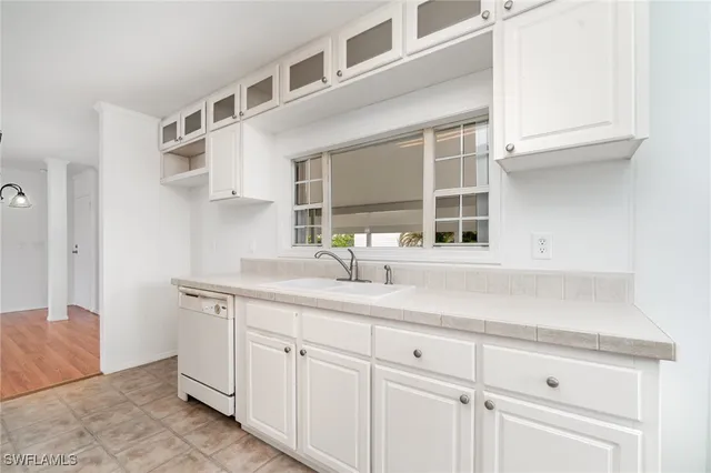 a kitchen with cabinets and window