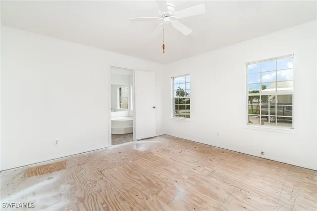 wooden floor in an empty room with a window