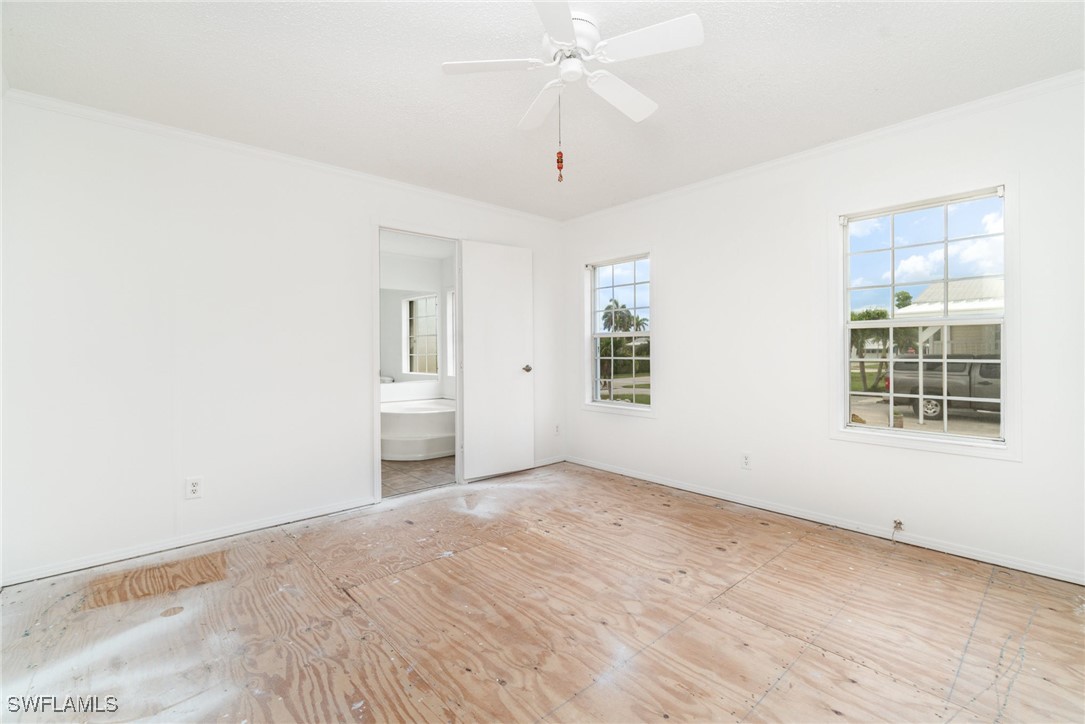 7679 Farrell Road Bokeelia, FL 33922 - Photo 16 of 34 wooden floor in an empty room with a window