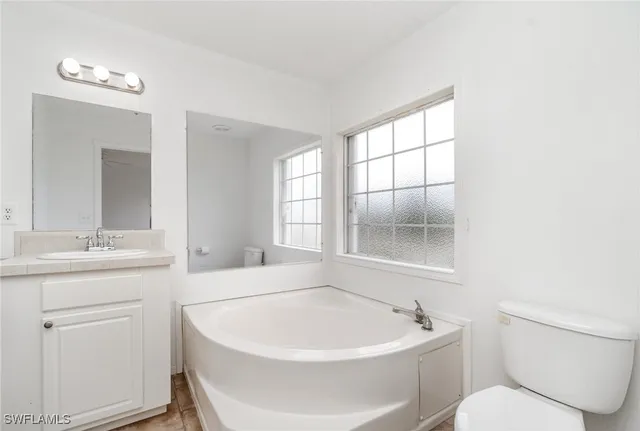 a white bath tub sitting next to a white sink