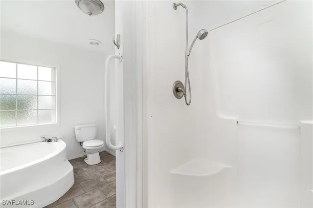 a bathroom with a shower a toilet and a sink