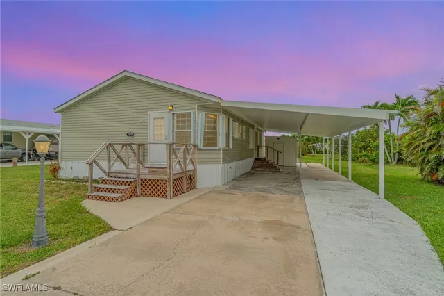 a front view of a house with a yard and entertaining space