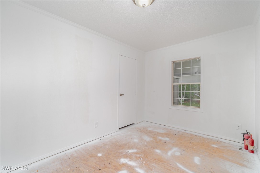 7679 Farrell Road Bokeelia, FL 33922 - Photo 25 of 34 an empty room with a window