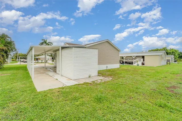 an aerial view of residential houses with outdoor space and river