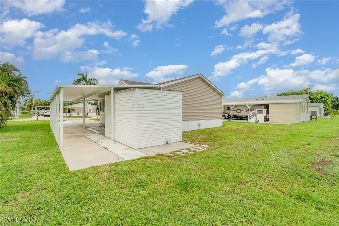 7679 Farrell Road Bokeelia, FL 33922 - Photo 28 of 34 a view of a house with a yard