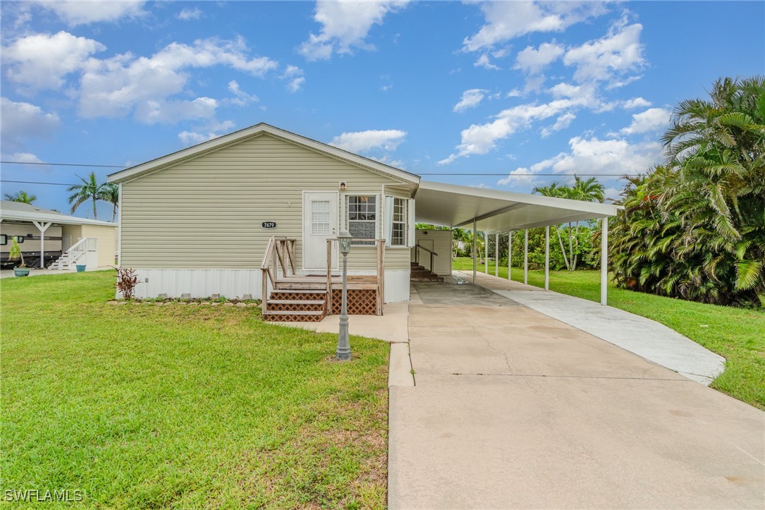 7679 Farrell Road Bokeelia, FL 33922 - Photo 3 of 34 a view of a backyard with a garden and plants