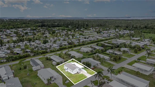 an aerial view of residential houses with outdoor space and river