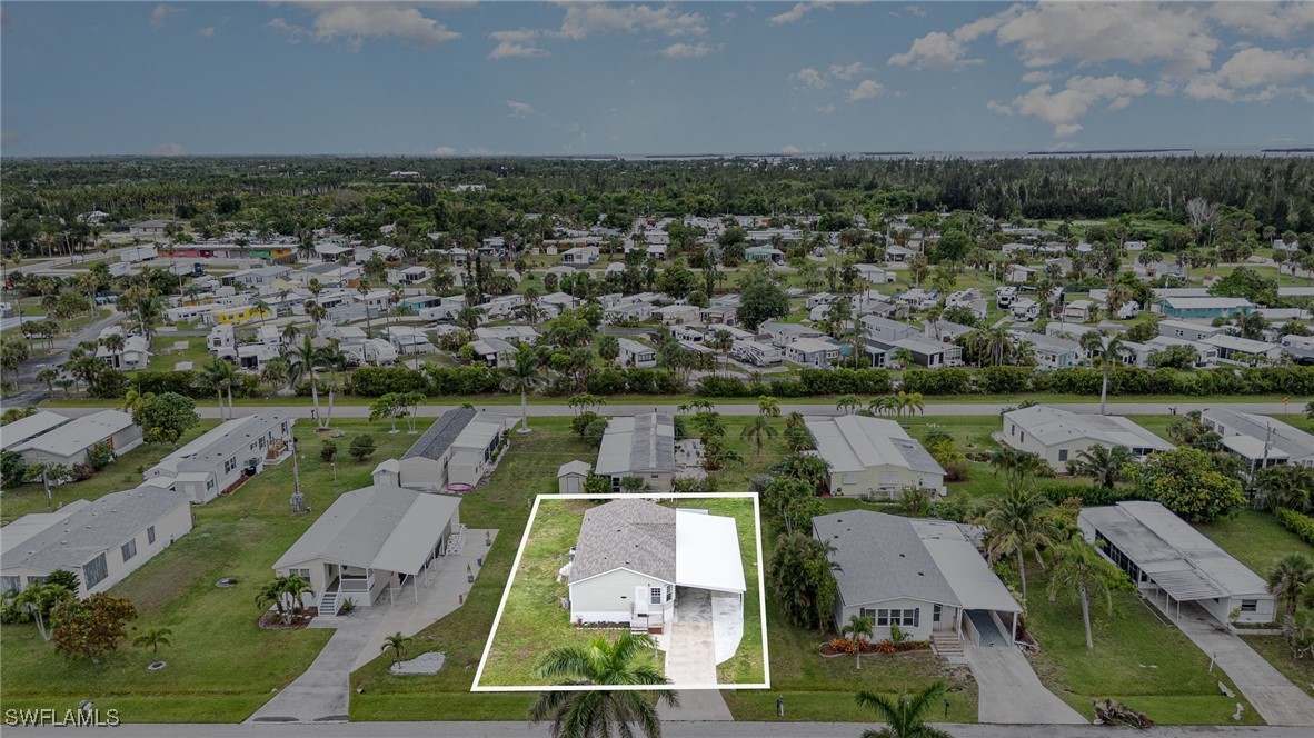 7679 Farrell Road Bokeelia, FL 33922 - Photo 32 of 34 an aerial view of residential houses with outdoor space and river