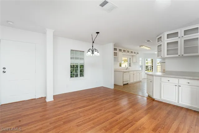 a view of a kitchen with wooden floor and windows