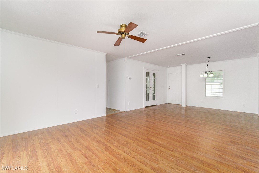 7679 Farrell Road Bokeelia, FL 33922 - Photo 9 of 34 a view of empty room with wooden floor and ceiling fan