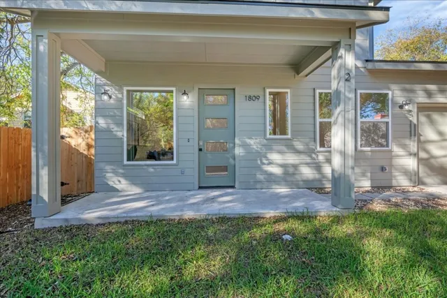 a view of front door of house with yard