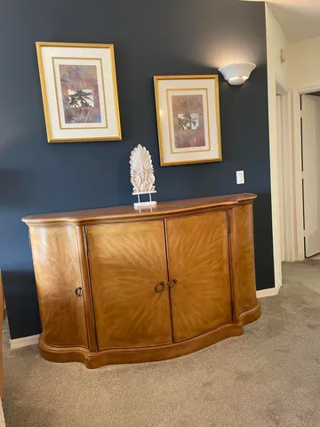 a view of a room with wooden door and glass door