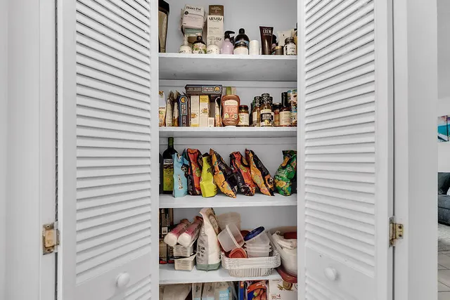 a view of a utility room with clothes and shoes