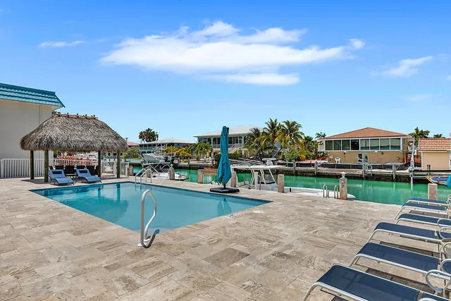 a view of a swimming pool with lawn chairs