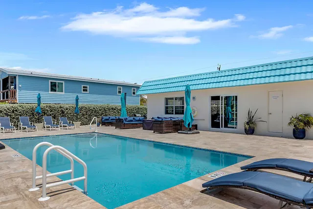 a view of a swimming pool with outdoor seating