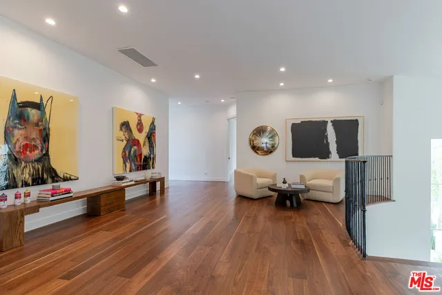 a view of a patio with couches table and chairs and potted plants