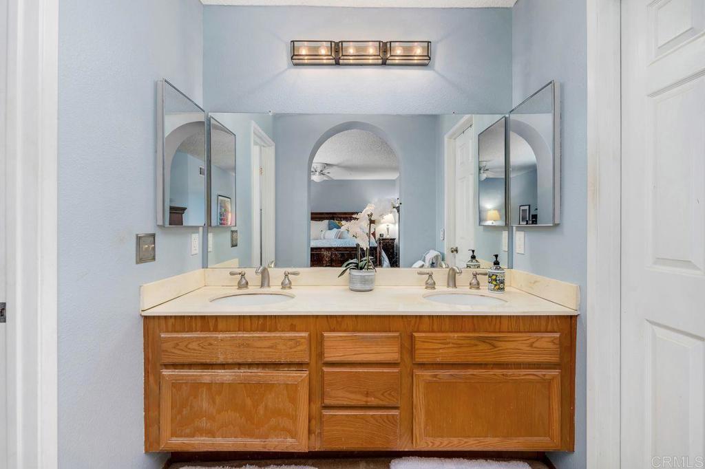 1064 Glen Arbor Drive Encinitas, CA 92024 - Photo 24 of 39 a bathroom with a sink vanity and mirror