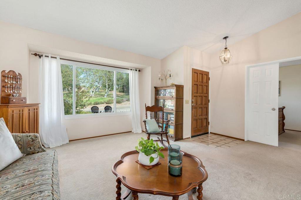 1064 Glen Arbor Drive Encinitas, CA 92024 - Photo 5 of 39 a living room with furniture potted plant and a window