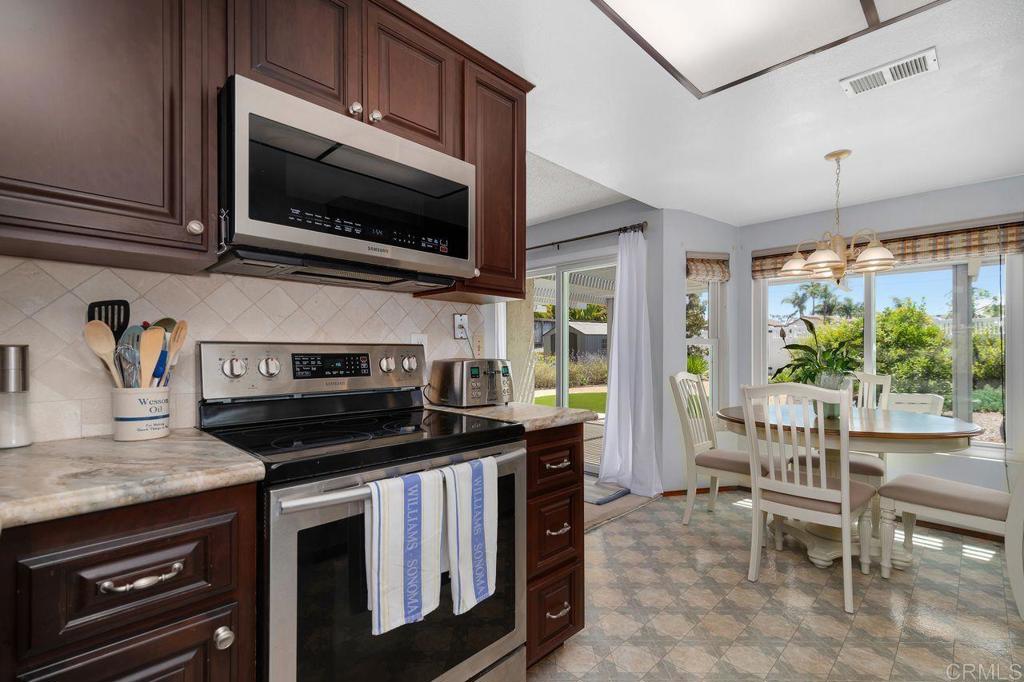 1064 Glen Arbor Drive Encinitas, CA 92024 - Photo 10 of 39 a kitchen with a stove a sink and a microwave