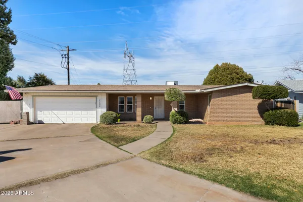 a front view of a house with yard and garage